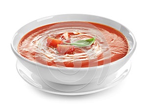 Dish with tomato cream soup on white background.