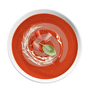 Dish with tomato cream soup on white background, top view.