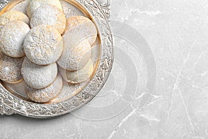 Dish of traditional cookies for Islamic holidays on table, top view with space for text.