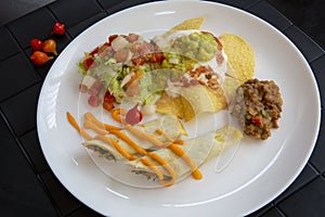Dish of typical Mexican food, on a black towel