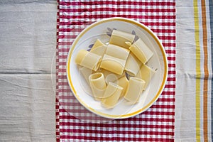 Dish of unseasoned paccheri pasta