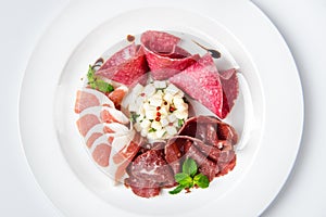 Dish of various types of meat-cutting on plate.