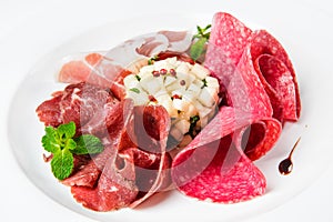 Dish of various types of meat-cutting on plate.