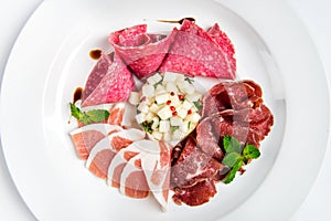 Dish of various types of meat-cutting on plate.