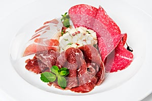 Dish of various types of meat-cutting on plate.