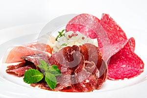 Dish of various types of meat-cutting on plate.