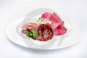 Dish of various types of meat-cutting on plate.