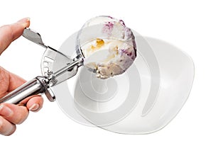 disher scoop with blueberry ice cream over bowl