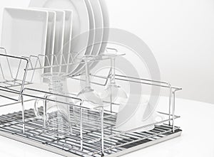 Dishes and glasses drying on metal dish rack