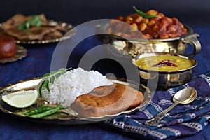 Dishes of national Indian cuisine on a dark blue background. traditional Indian home-cooked dinner. rice, dal, sabji, aloo