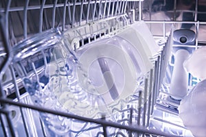 Dishes in the open dishwasher Inside, clean dishware. dishwasher interior.