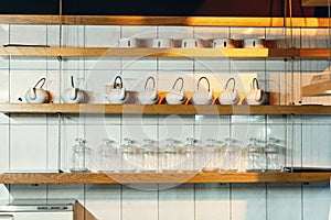 Dishes on the shelves in the restaurant on a light background