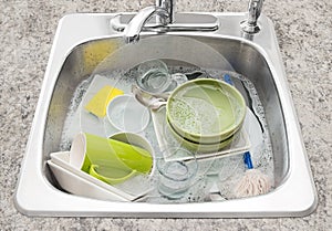 Dishes soaking in the kitchen sink photo