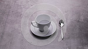 Dishes on the table, an empty cup with a spoon on a dark background.