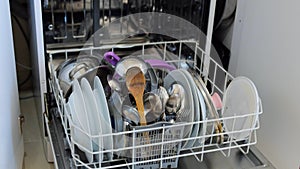 Dishes to be washed in the dishwasher, dishwasher with the front door open