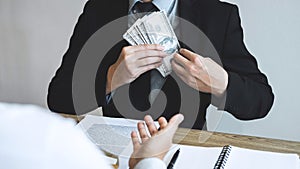 Dishonest cheating in business illegal money, Businessman receive bribe money in business people to give success the deal contract