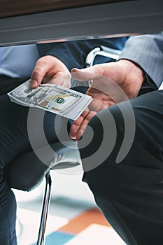 Dishonest rich businessman giving a bribe photo