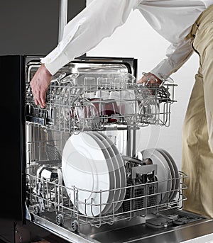 Dishwasher tray holding by man