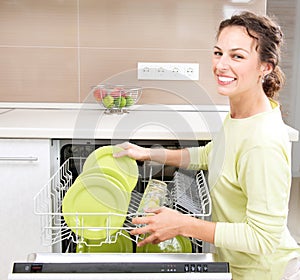 Dishwasher. Young woman doing Housework