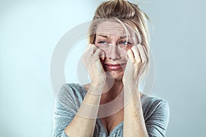 Disillusioned woman crying with big tears expressing sadness