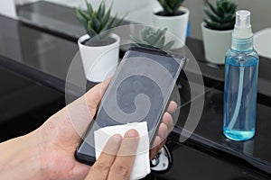 Disinfect, sanitize, hygiene care. cleaning fingerprint on mobile phone touch screen for disinfection, prevention of germs