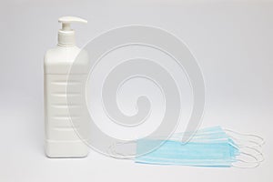 A disinfectant bottle and surgical masks