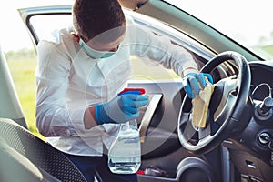 Disinfecting inside car, wipe clean surfaces that are frequently touched, prevent infection. photo