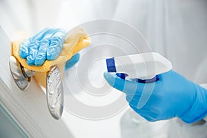 Disinfection and cleaning door handles of house from infection with virus and microbes in biochemical suit. Coronavirus