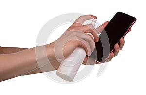 Disinfection of the phone. Female hands spray antiseptic on phone isolated on white