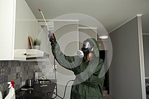 Disinfection of premises against insects and rodents by chemical means, a sanitary worker with a spray on the background of the