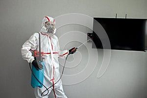Disinfection of premises against insects and rodents by chemical means, a sanitary worker with a spray on the background of the