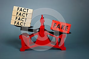 Disinformation and propaganda concept. Scales with facts and fake news. photo