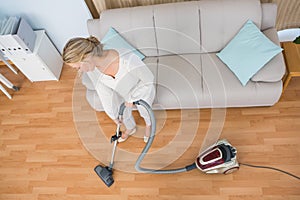 Disinterest woman cleaning her living room