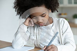 Disinterested in study african little schoolgirl do homework at home