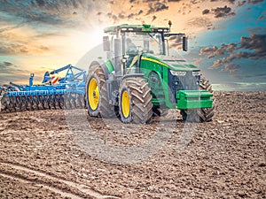 Disking soil with a tractor in Central Russia in the spring season.