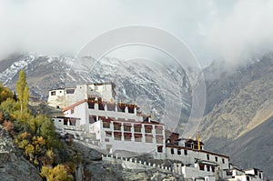 Diskit Monastery in Ladakh, India, surrounded by mist covered mountains