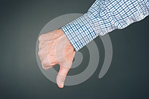 Dislike and disapprove hand gesture with thumb down