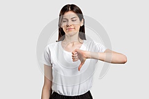 Dislike gesture criticizing woman thumb down