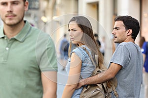 Disloyal woman looking another man and her angry boyfriend