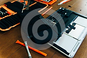 Dismantle laptop with tools and battery, display, hard disk and other components
