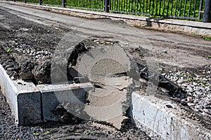 Dismantled asphalt for road repair is on curb