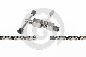 dismantled bicycle chain, chain link puller, tool