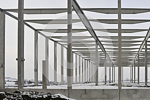 A dismantled factory hall in winter. Construction site during winter. The concept of the end of the building season and