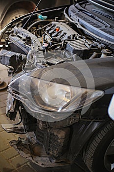 Dismantled Front of a Car in the Garage