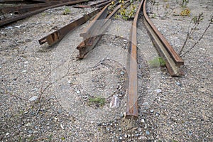 Dismantled railroad rails on ground outdoors