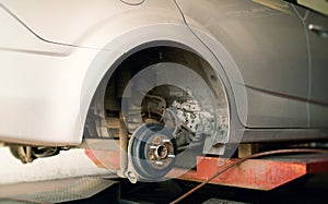 Dismantled wheel and deformed drum brake system during vehicle maintenance