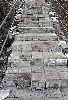 Dismantling damaged old steps on ladder during renovation