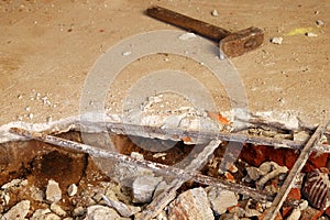 Dismantling, disassembling the floor. Smashed concrete and bricks floor. Destroying concrete surface. Renovation, old