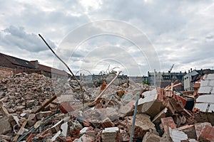 Dismantling of an old building against the background of a cloudy sky