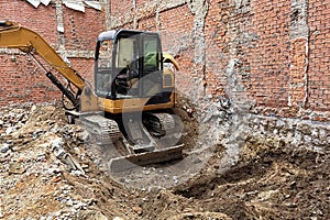 Dismantling of an old house with an excavator